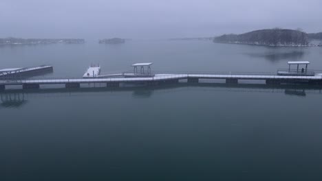 snow covered piers in detroit river international wildlife refuge humbug marsh unit on moody winter day in detroit, aerial view