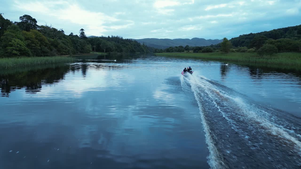 una lancha rápida conduce a lo largo del río al anochecer