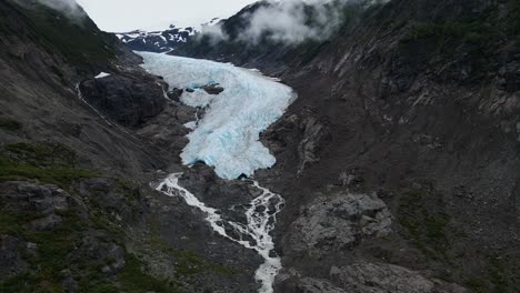 Bear-Glacier-cutting-through-a-mountain-into-Strohn-Lake-in-Bear-Glacier-Provincial-Park,-British-Columbia,-Canada