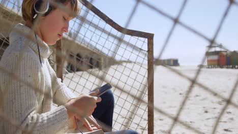 girl using mobile phone at beach 4k