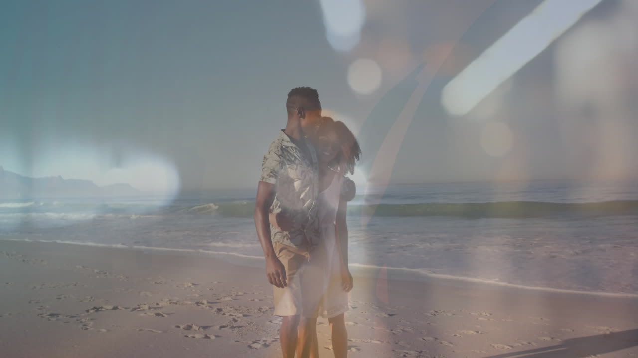 Walking on beach, couple with abstract light reflections overlay, creating animation