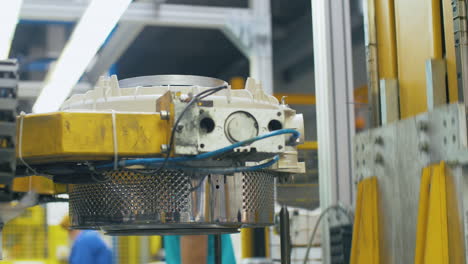 Metal drums for washing machine moving on production conveyor at factory