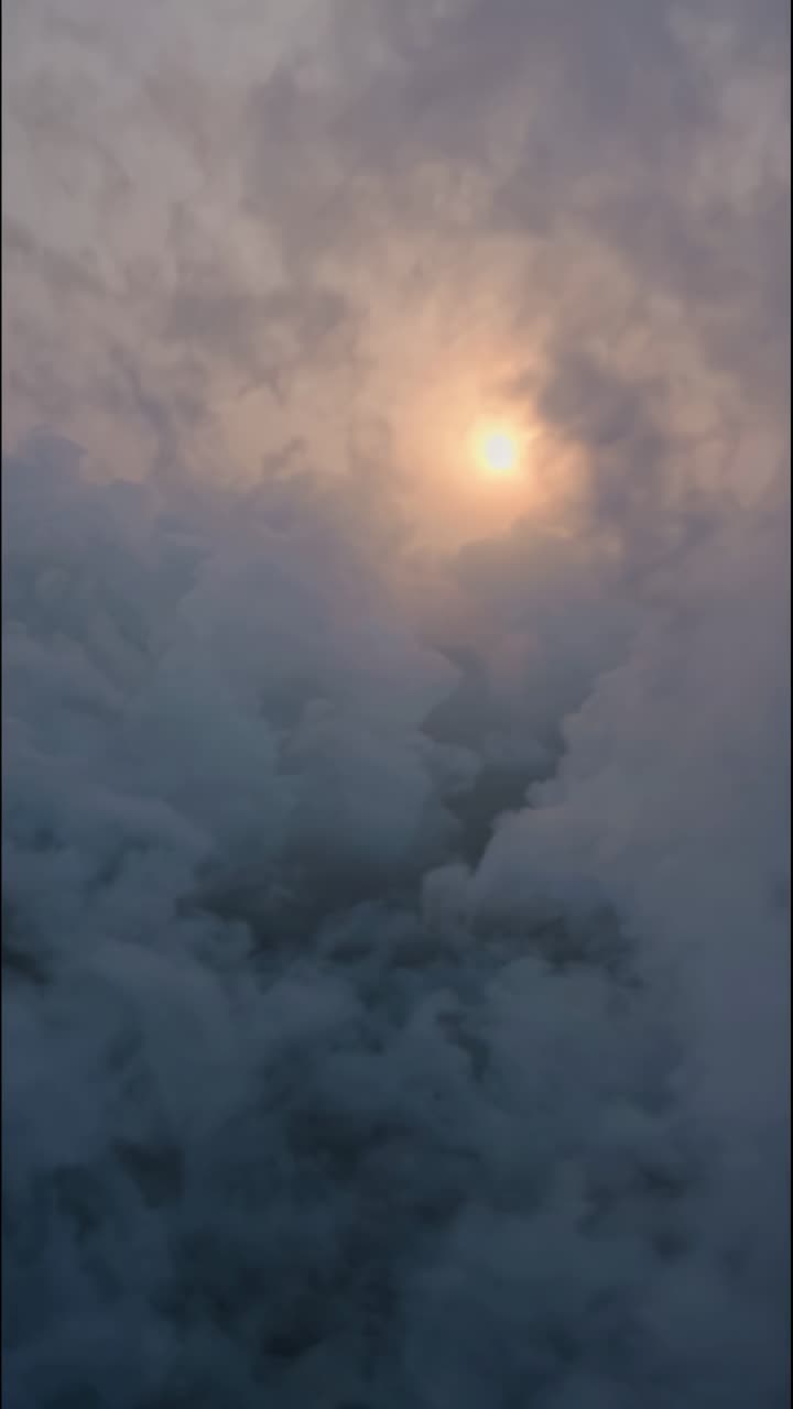 Aerial video captures a mysterious, foggy landscape with a glowing orb