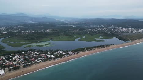 aerial cityscape of barra de navidad beach town in mexican coastline landscape, panoramic blue sea and skyline