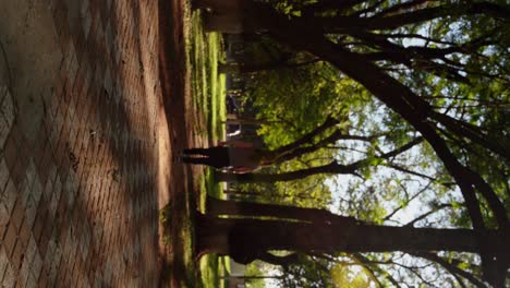 young woman walking in a park with many trees around