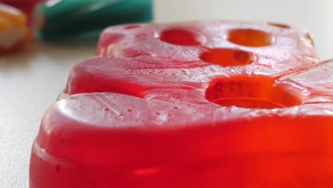 Close-up-horizontal-panning-on-big-jelly-bear-on-a-table-in-studio-enviroment-at-home