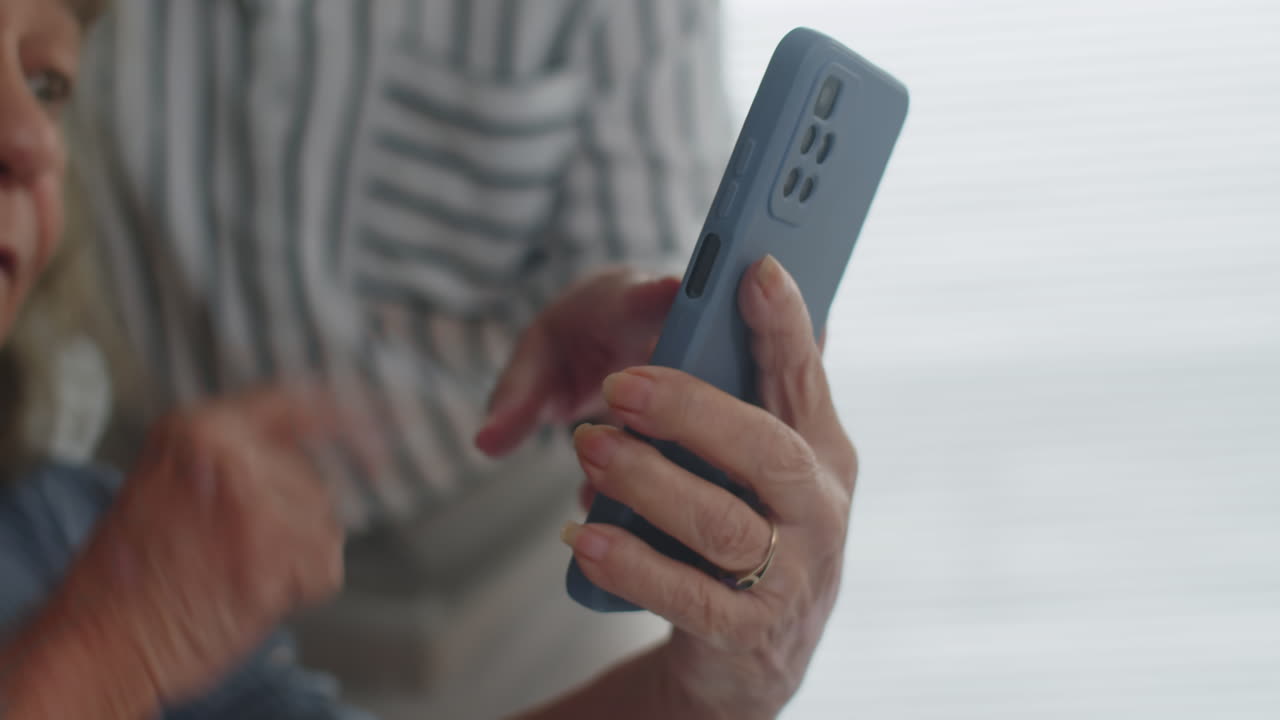 Aged Woman Asking Person How to Use Smartphone