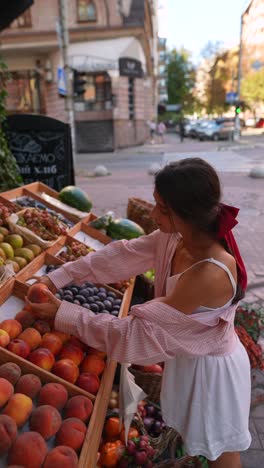 woman shopping for fruits at a street market