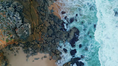 stormy ocean waves splashing foaming on rocky coast. aerial view stunning surf.
