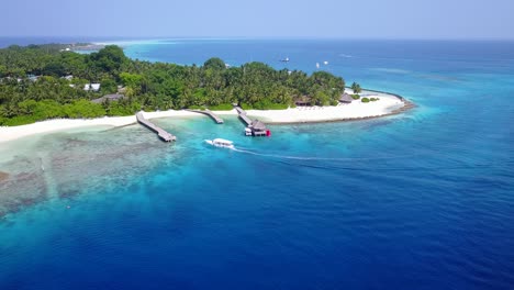 paradise tropical island with luxurious resort, white sandy beach and piers with docks into small harbor for anchoring coming boats from caribbean islands