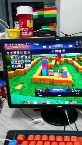 gaming setup with block-style game on desktop