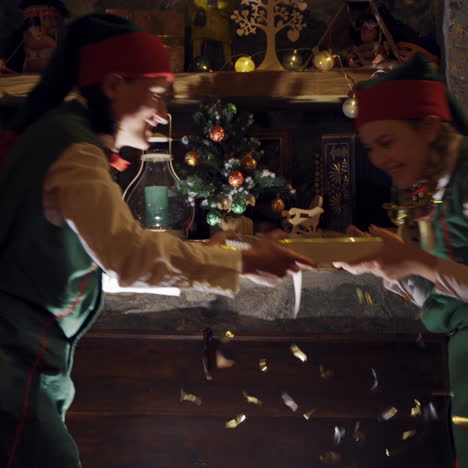 surprised elves open the big chest in darkness. santa's helpers elves open magic chest and taking beautiful box on christmas decor background.