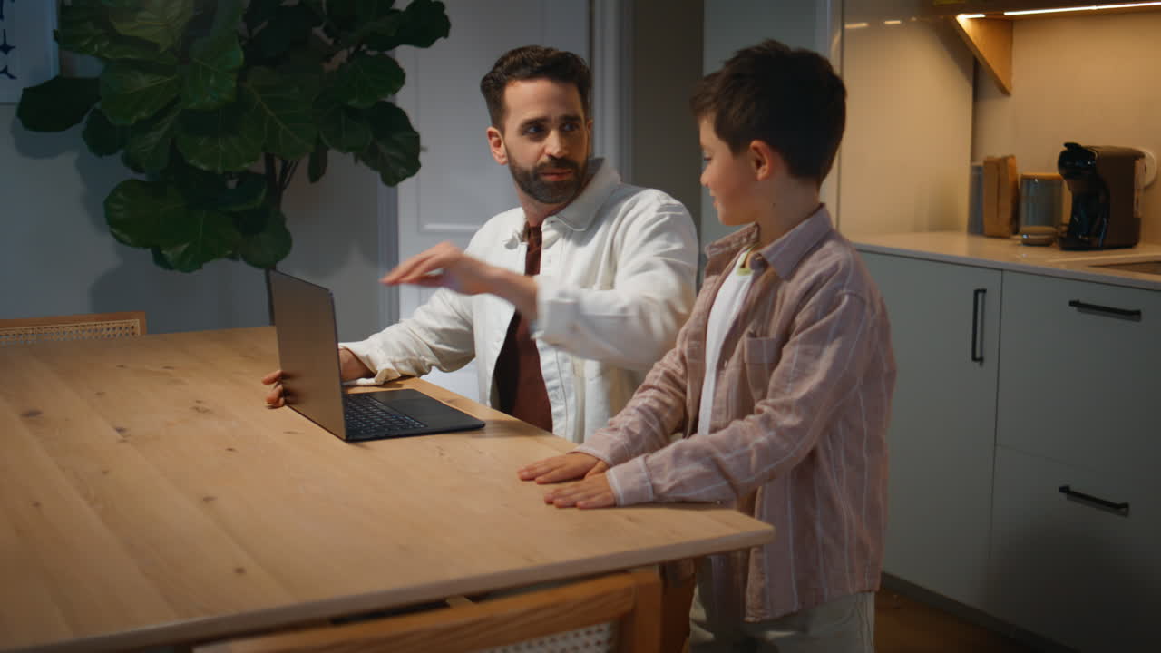 Bored child talking father at evening closeup. Disturbed man closed computer