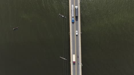 fishing boats using nets under the highway bridge