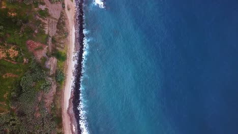 Aerial-topdown-shot-of-rocky-coast-at-Madeira-with-Atlantic-ocean