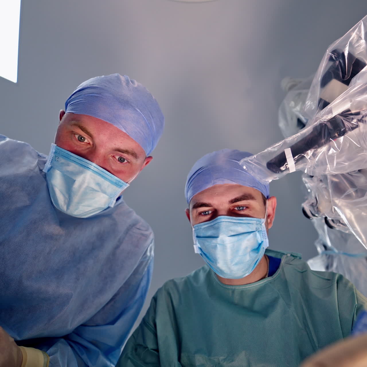 View from below of experienced surgeons with medical tools during operation