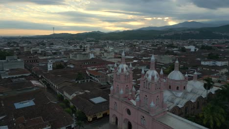 aerial view of a pink church in a colombian city at sunset