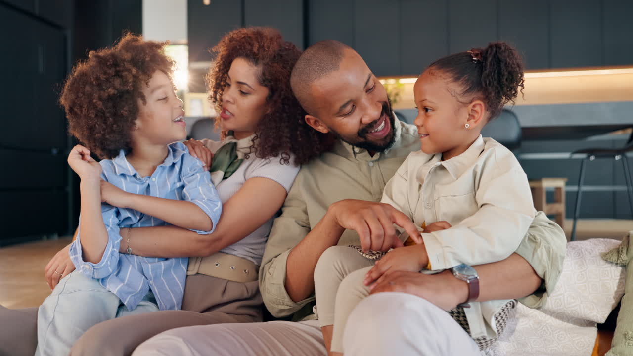 A loving African American family sitting together on a couch