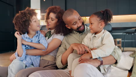 a loving african american family sitting together on a couch