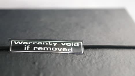 close-up of a 'warranty void if removed' sticker