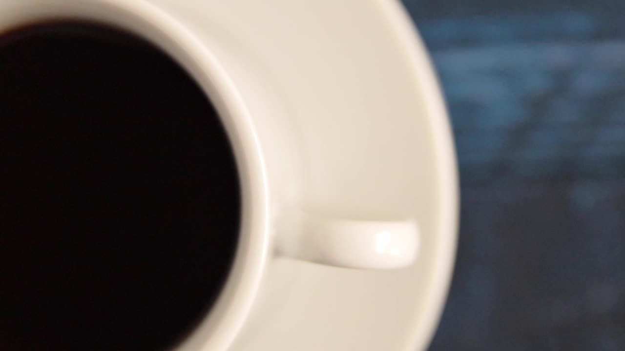 Coffee spinning on a blue table