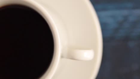 coffee spinning on a blue table