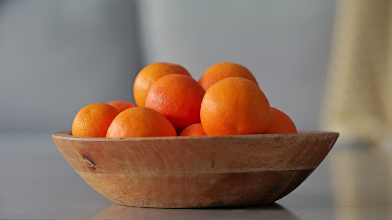 Hand grabbing fresh organic blood orange fruit. Slow motion 4K
