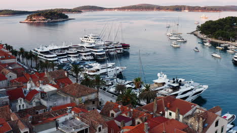 super yachts and pleasure boats for tourists docked at port by adriatic sea in hvar, croatia