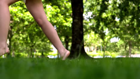 womans feet walking on grass