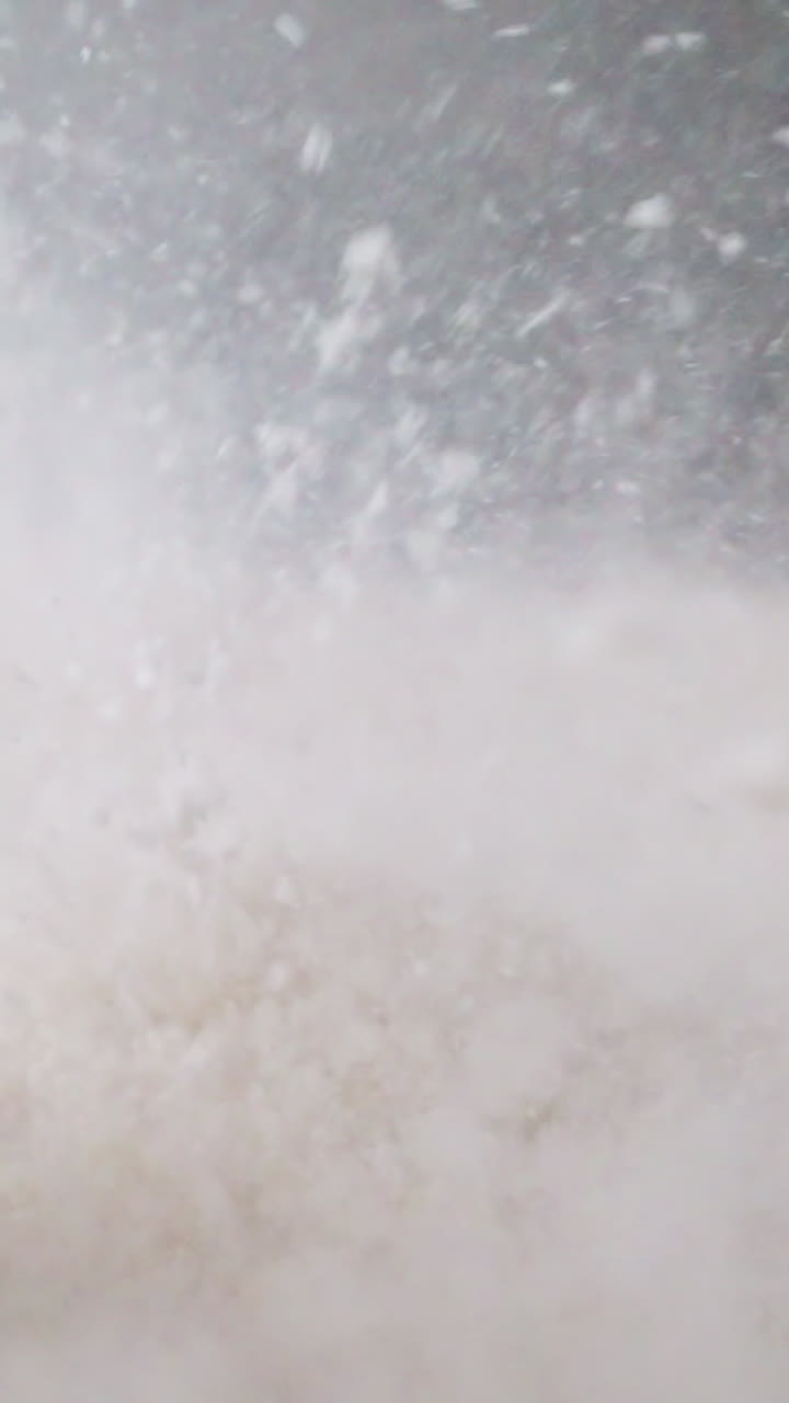 White powder bounces rhythmically on diaphragm of switched-on speaker. Element of device moves under influence of electromagnetic field forming sound waves macro