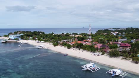 barcos de buceo aéreos de gran tamaño amarrados en los resorts de buceo de bounty beachfront, isla de malapascua, filipinas