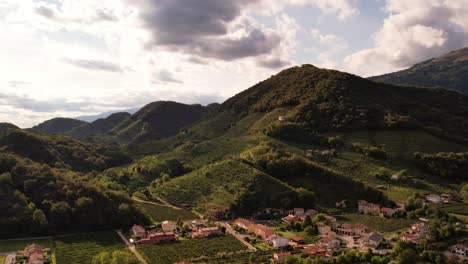 Aerial-panoramic-landscape-view-over-the-famous-prosecco-hills-with-vineyard-rows,-Italy,-on-a-cloudy-evening