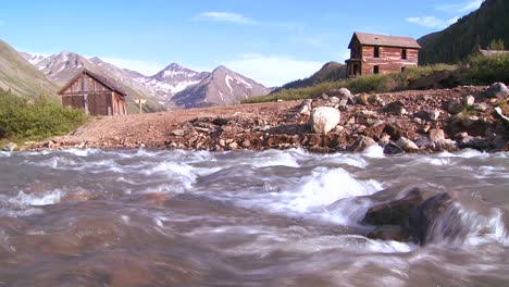 traveling shot along a river with colorado ghost town background