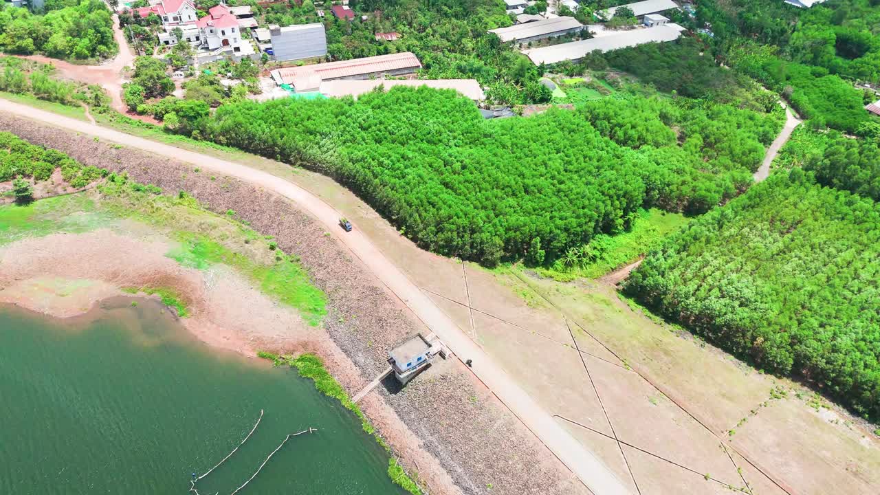 Aerial View of a Car Driving on the Dam in Dong Nai.