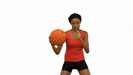 pretty woman playing basketball on white screen in slow motion
