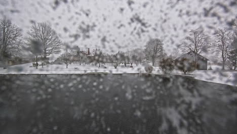 lake during rainy day in snowy landscape