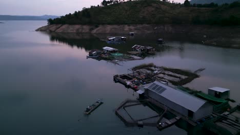 floating houses on a mountain lake at dawn/dusk