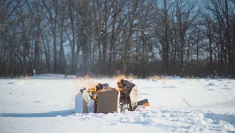 time-lapse garbage burning in the middle of a field in winter