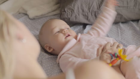 Mum-looking-at-playful-baby-daughter