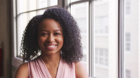 Young-black-businesswoman-smiling-to-camera,-close-up