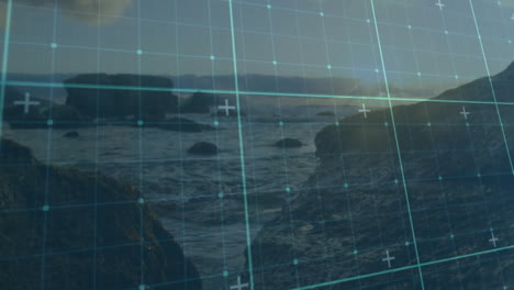 digital grid overlaying rocky shoreline with ocean landscape in background