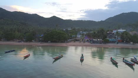 boats in the ocean at a tropical beach