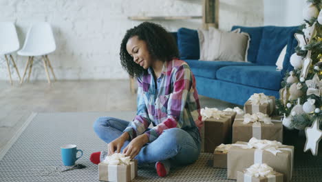 young woman wrapping christmas presents