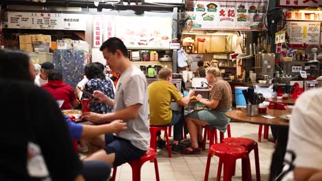 people enjoying meals at a bustling street restaurant