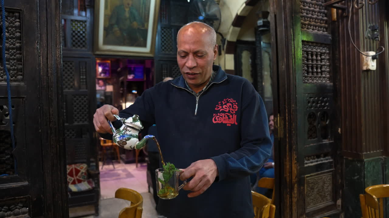 Man Pouring A Herbal Tea At Coffee Shops In Cairo, Egypt. - Medium Shot, Slow Motion