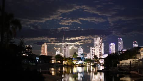 timelapse of illuminated city skyline and water reflections