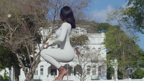 a young girl wearing a white bodysuit spends a day in the city with whitehall castle in the background