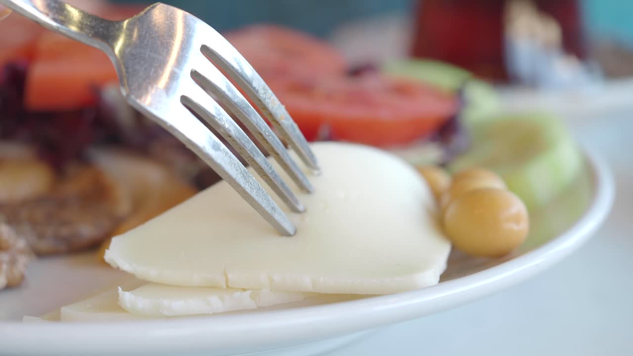 Person eating a Turkish breakfast meal