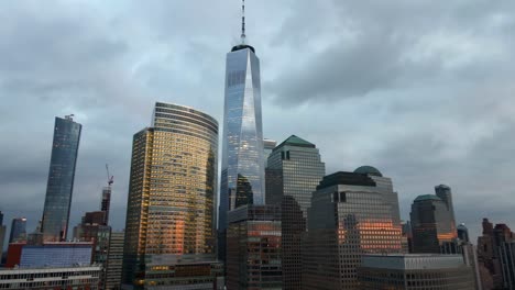 aerial view around sunset lit high rise in manhattan, dramatic evening in new york - circling, drone shot