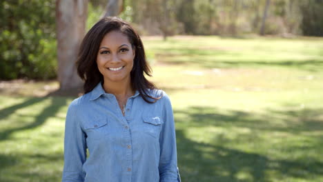 mixed race woman in countryside walks in to focal plane